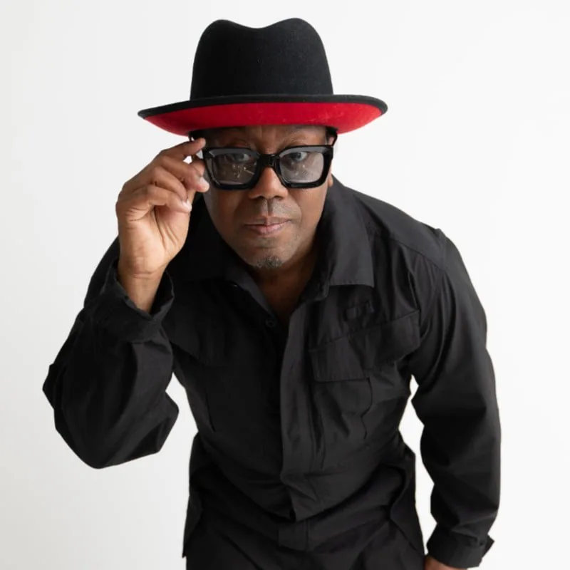 Nick Cooper in a black hat with a red brim