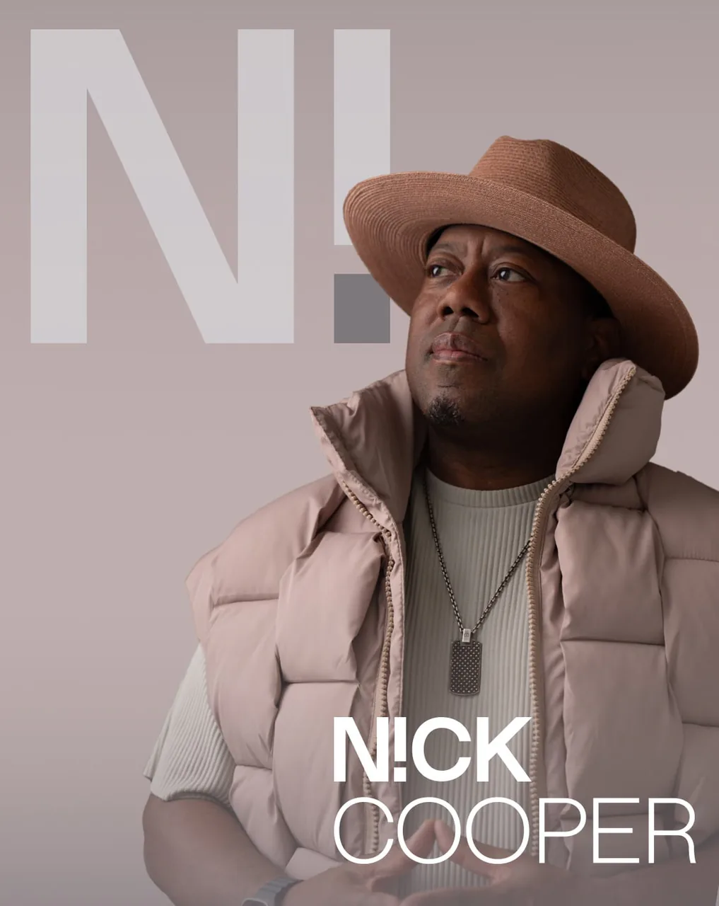 Nick Cooper in a straw hat beside his N! mark